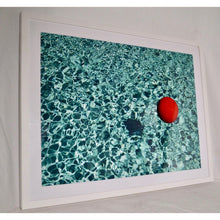 Load image into Gallery viewer, Floating Red Ball In Blue Rippled Water By Mark A Paulda Framed Print

